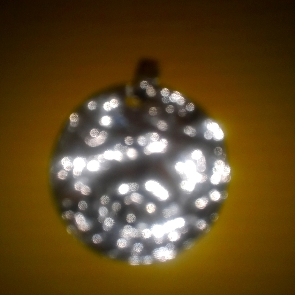 This is a silver pendant for a chain. It's very nice.